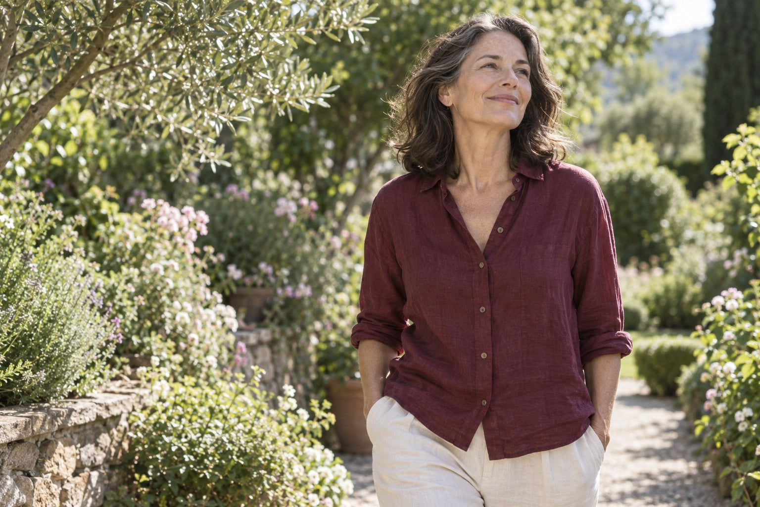 A woman enjoying a sunlit garden